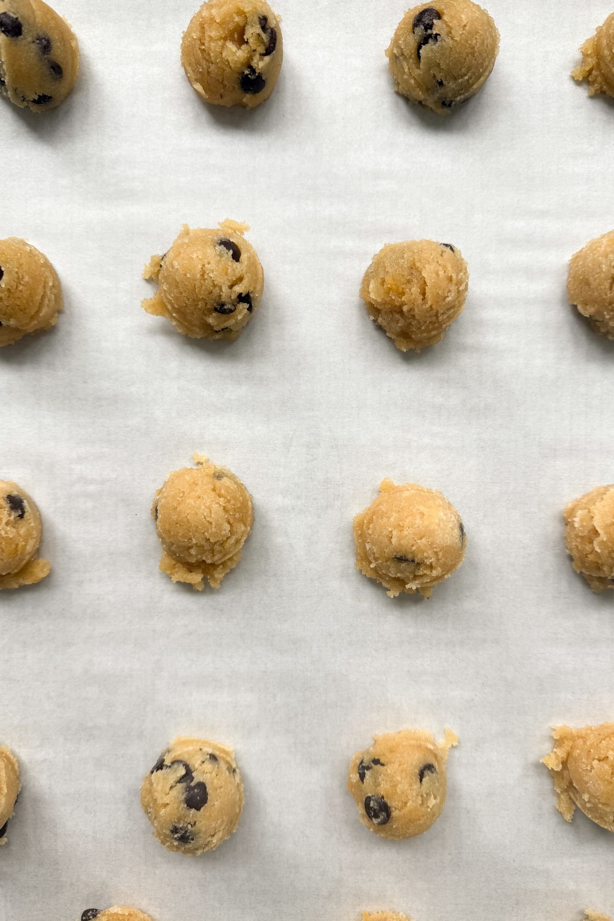 Almond flour chocolate chip cookie dough on a baking sheet.