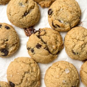 Almond flour chocolate chip cookies on white parchment paper.