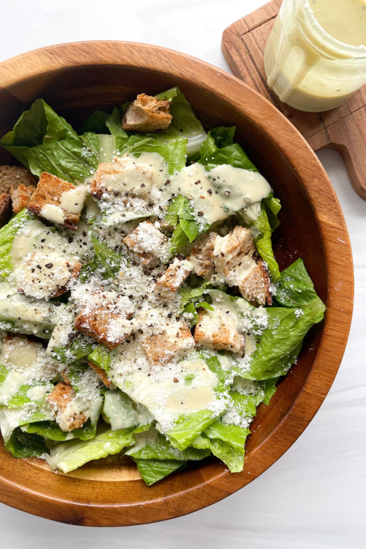 Tahini Caesar salad in a wooden bowl.