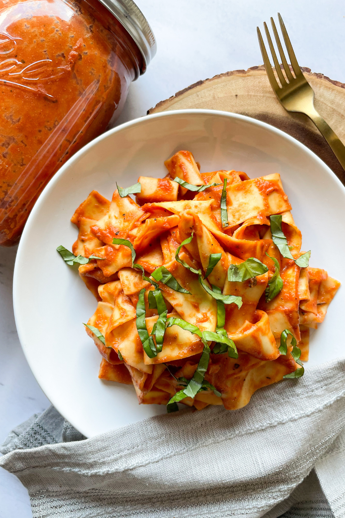 pasta with vegan tomato cream sauce on a white plate