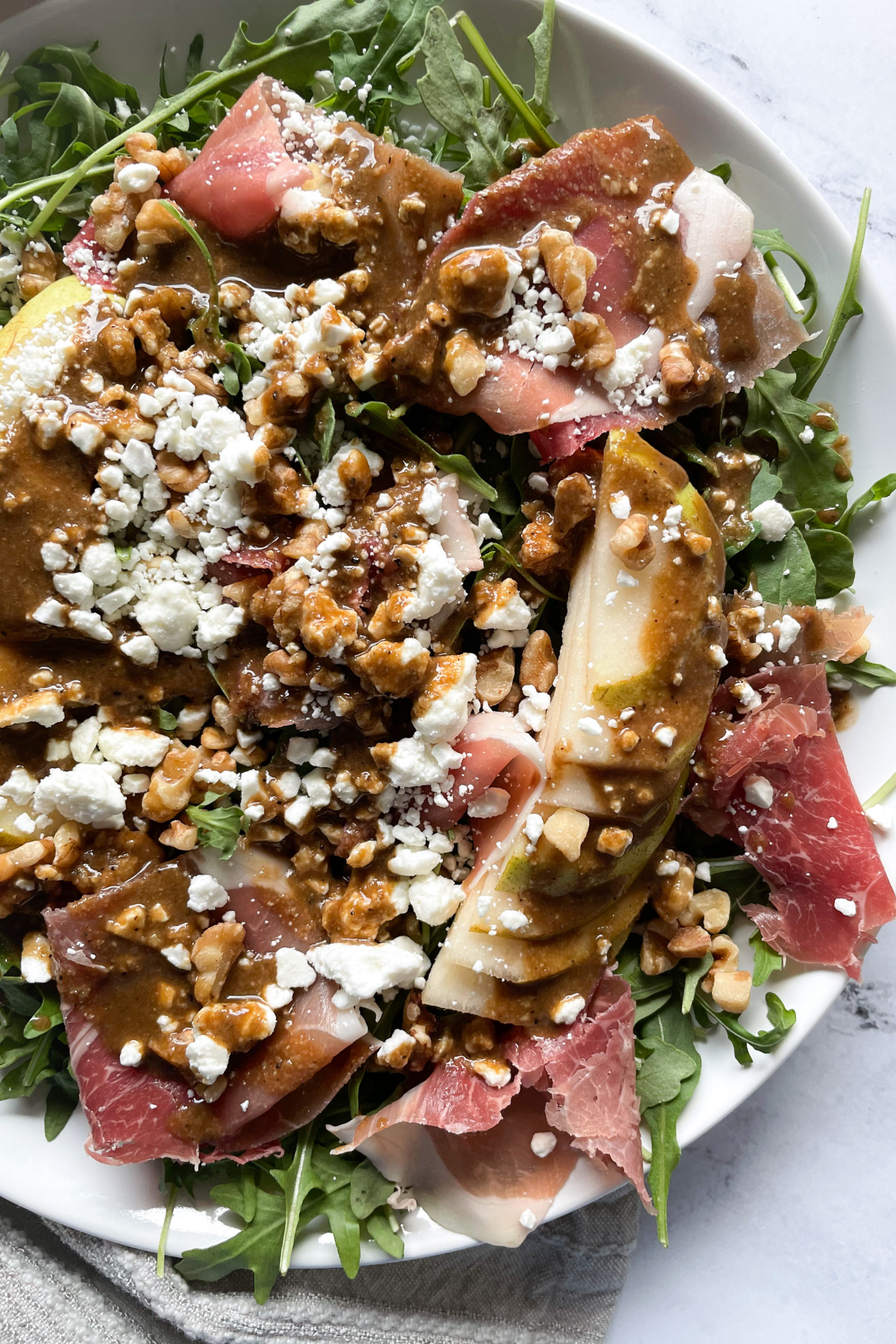 Pear and Prosciutto Salad on white plate