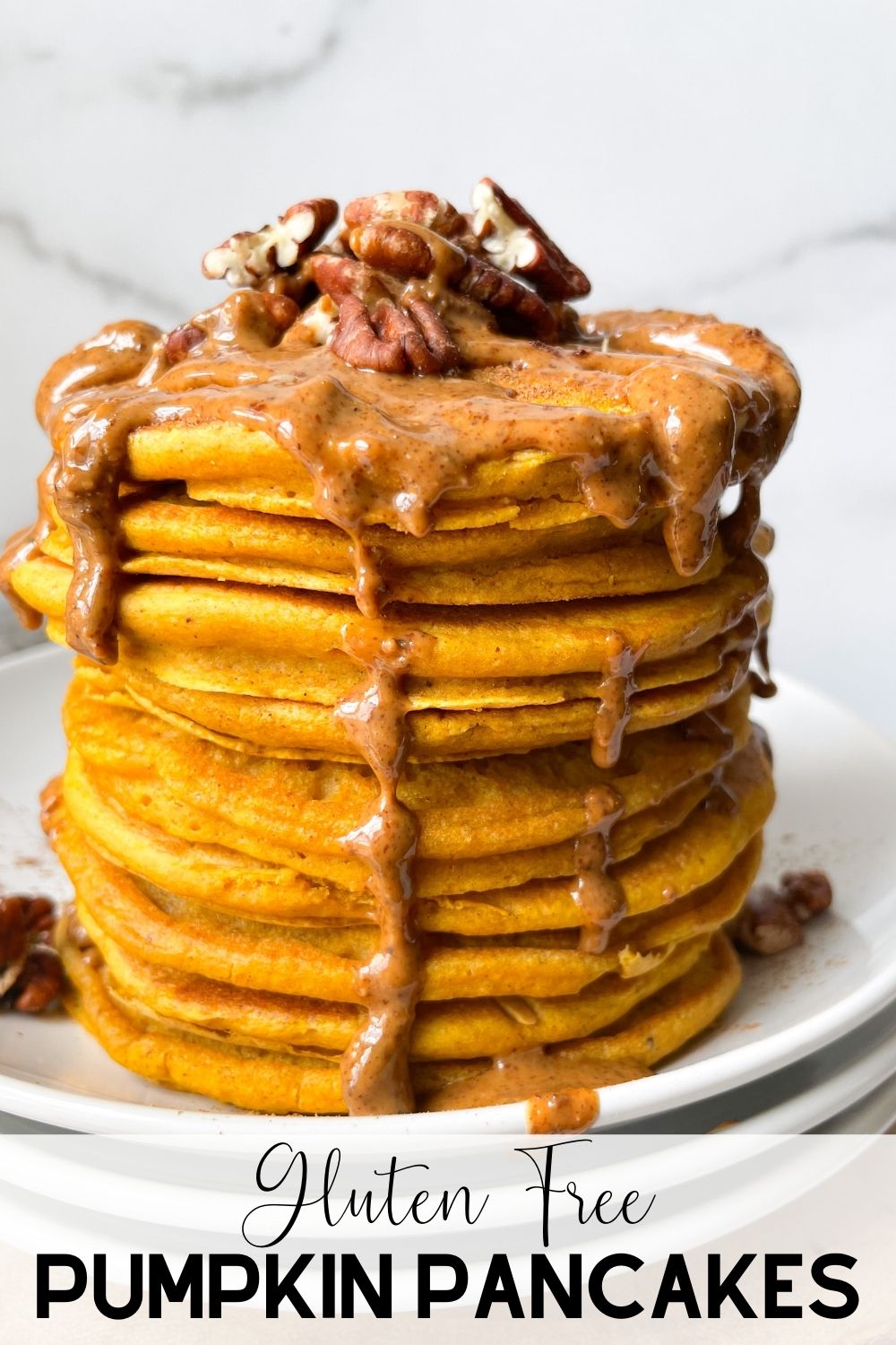 stacked pumpkin pancakes with almond butter and pecans