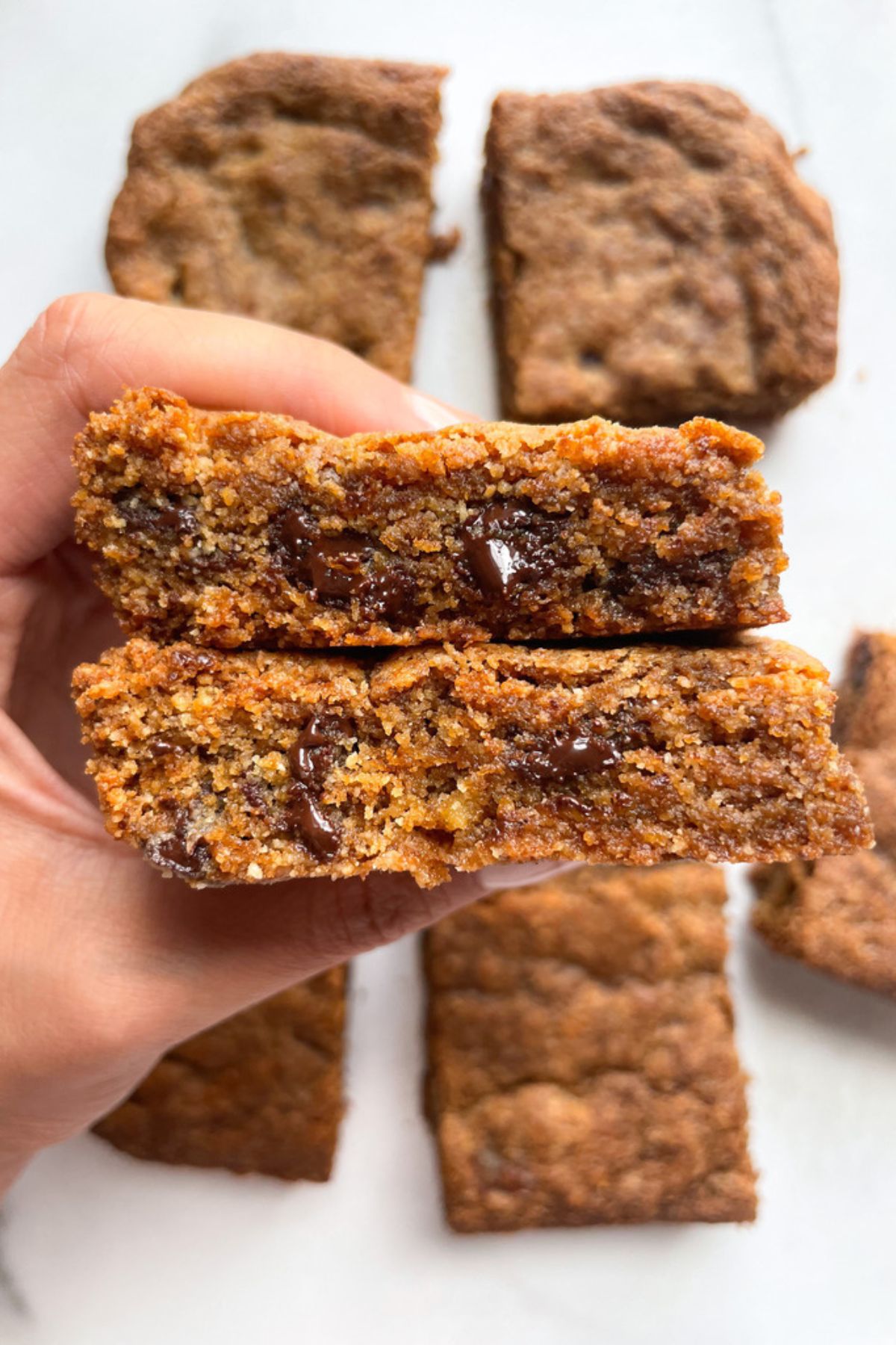 Hand holding tahini blondies.