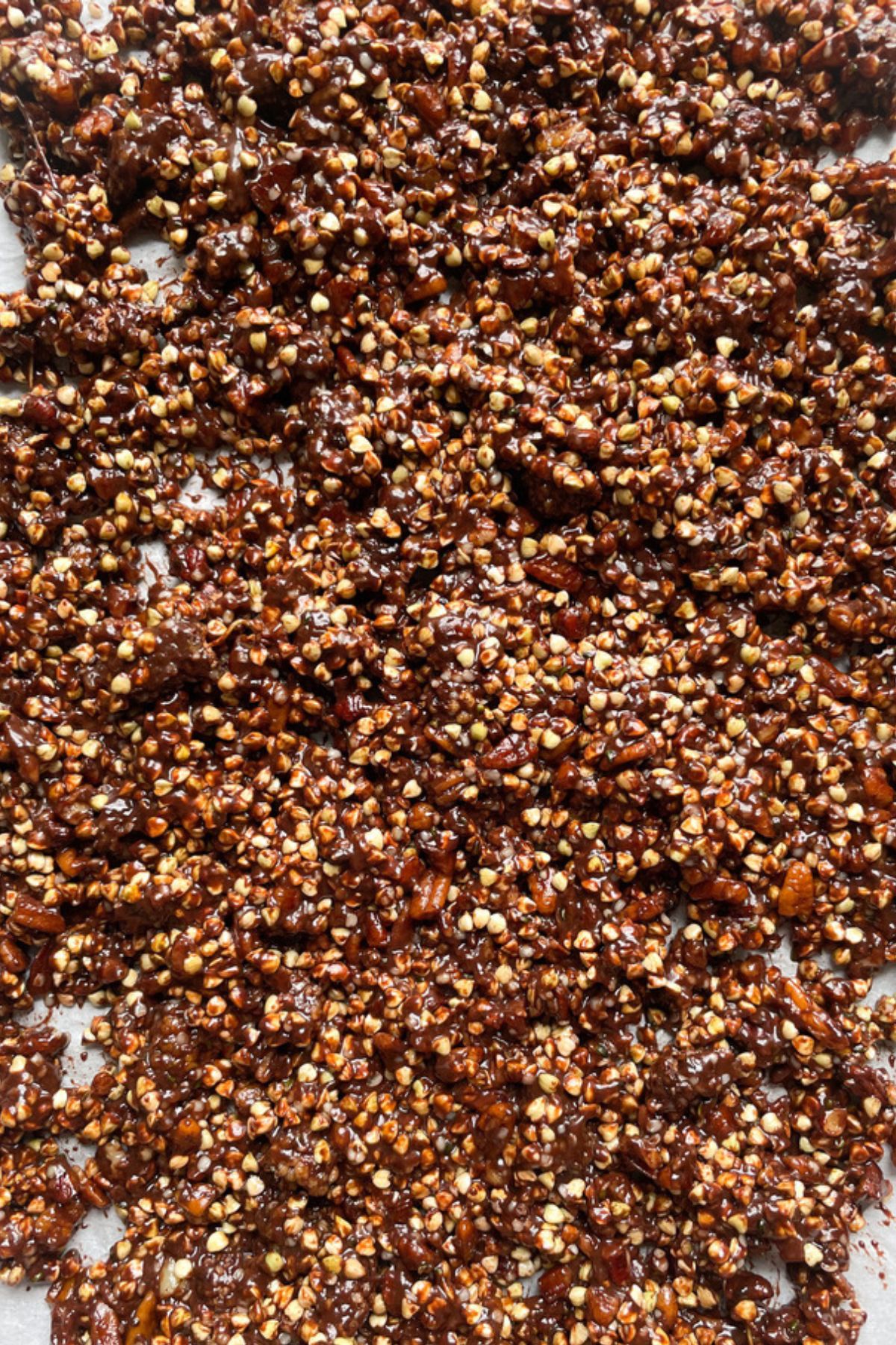 Uncooked buckwheat granola on a baking sheet.