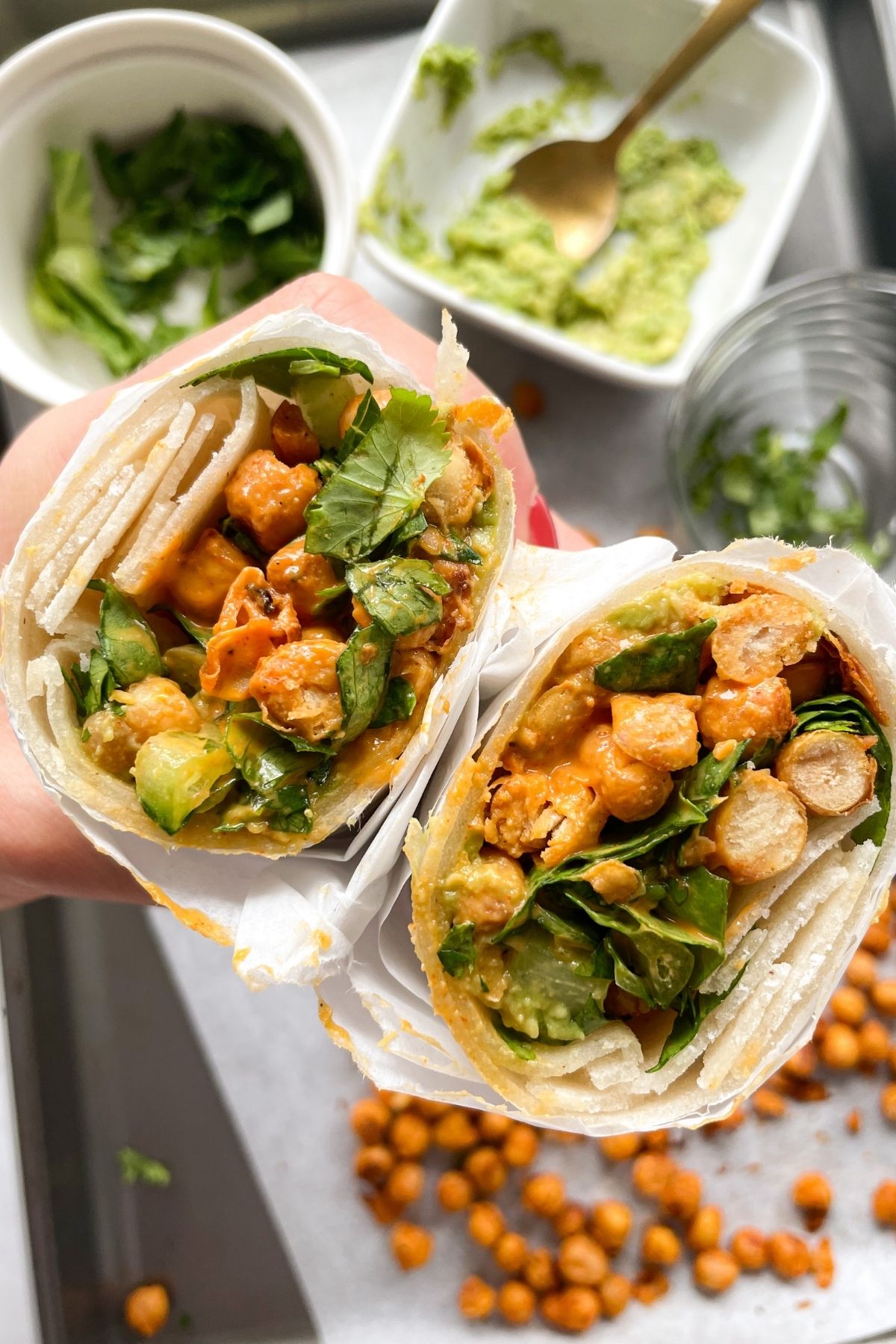 hand holding Buffalo Chickpea Wrap