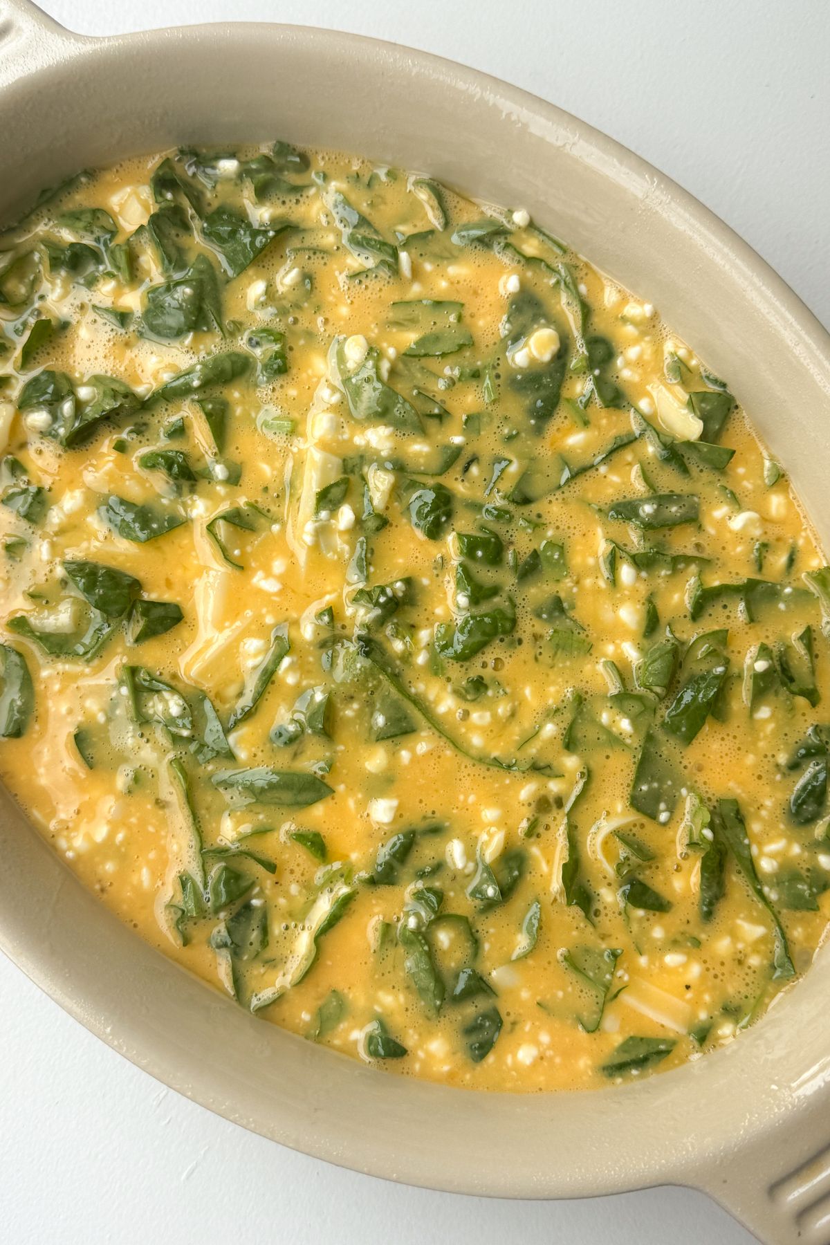 Unbaked cottage cheese egg bake in a baking dish.